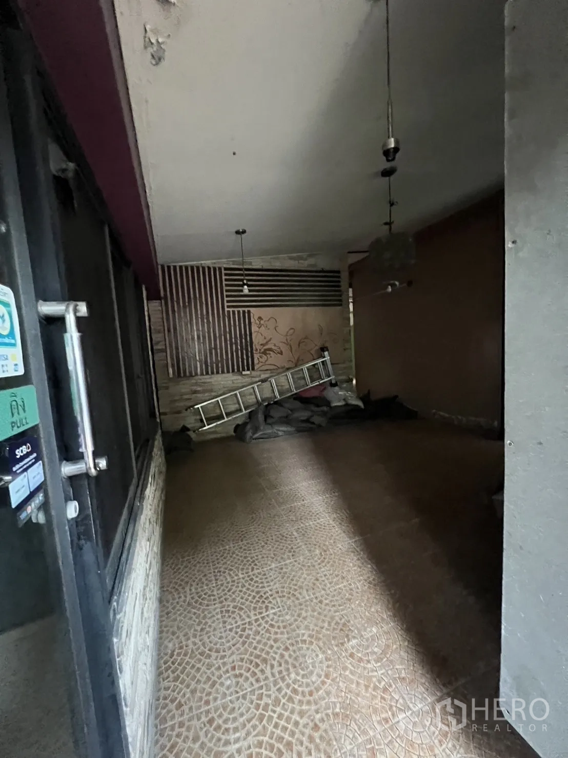 Retail Space for rent in Watthana, Bangkok - Covered walkway with tiled floor and pendant lights inside the shop space.