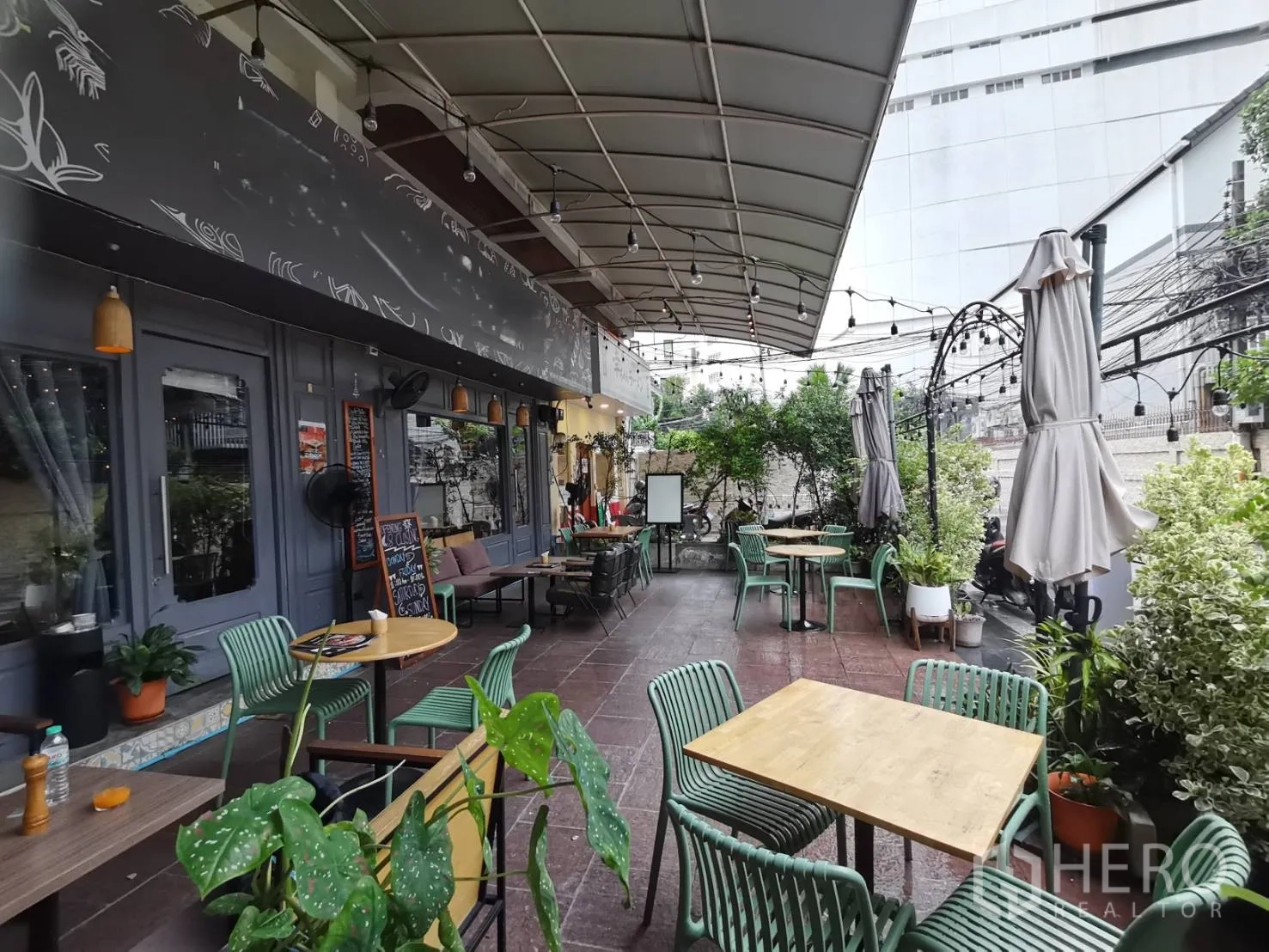 Retail Space for rent in Watthana, Bangkok - Covered terrace dining area with string lights, greenery and café tables.