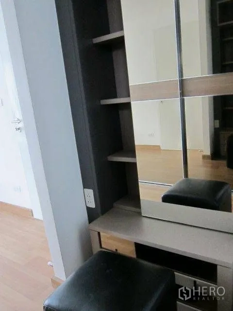 Condominium for rent in Khlong Toei, Bangkok - Bedroom vanity area with mirror, shelving, and a cushioned stool.