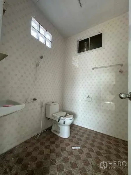 Warehouse for rent in Pathum Thani - Restroom with toilet, shower, tiled walls and a small glass-block window.