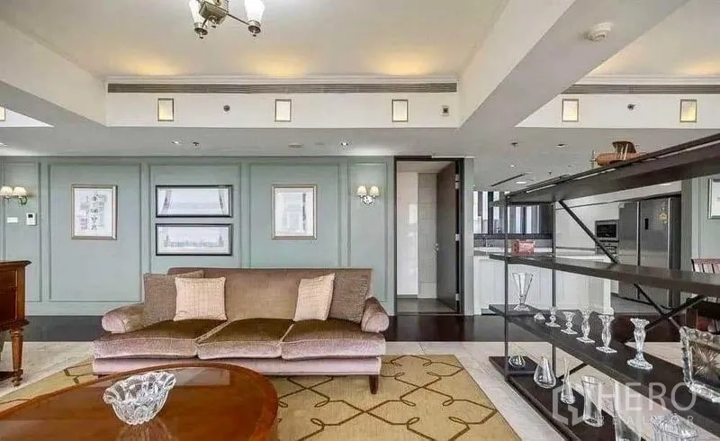 Condominium for rent - Living area with display shelving, sofa and paneled feature wall.