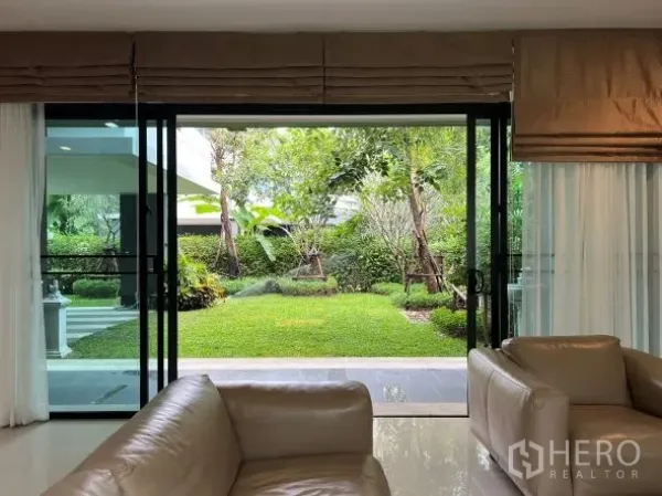 Detached House for rent or sale in Bang Kapi, Bangkok - Garden view from the living room through wide sliding glass doors to a private landscaped yard.