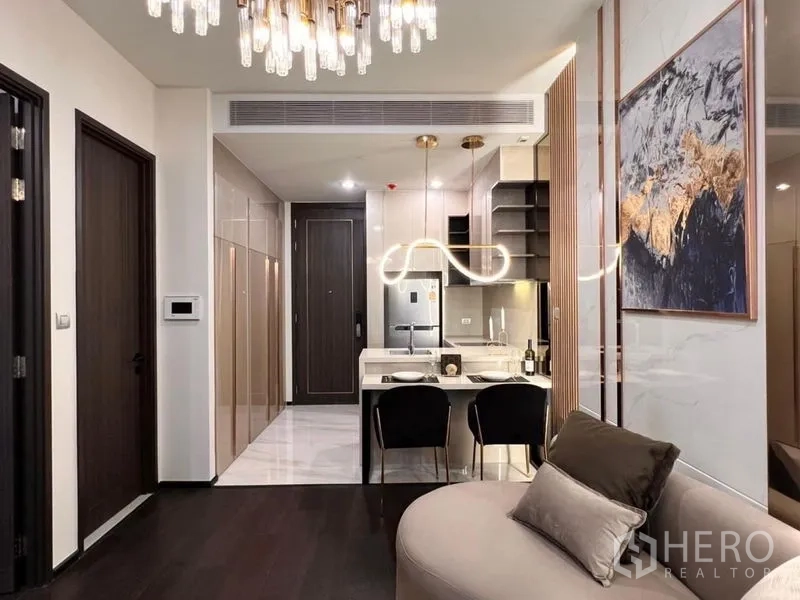 Condominium for rent in Watthana, Bangkok - Open-plan kitchen and dining bar with glossy cabinetry and sculptural lighting in a Watthana Bangkok condo.