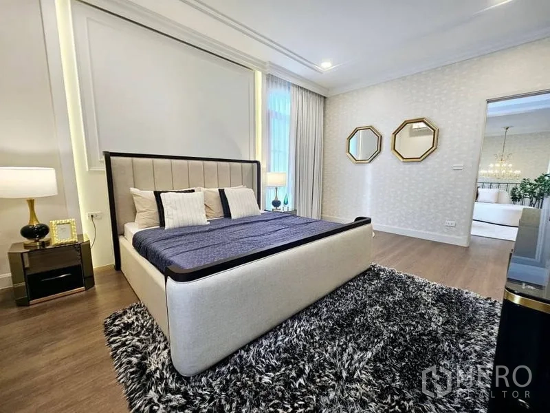Detached House for rent or sale in Saphan Sung, Bangkok - Stylish bedroom with upholstered bed, dark shag rug and warm lighting.