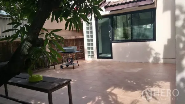 Detached House for rent - Spacious tiled patio beside sliding glass doors shaded by trees.