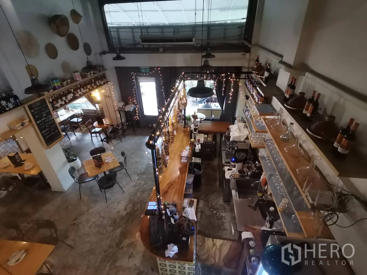 Retail Space for rent in Watthana, Bangkok - Overhead view of the bar station, shelves and seating in a double-height space.