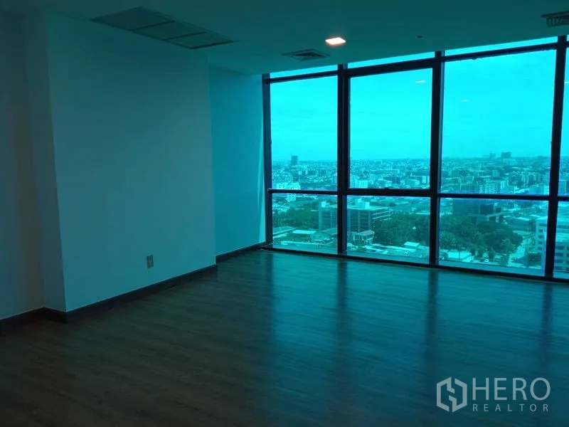 Office Space for rent in Din Daeng, Bangkok - Corner office space with wood flooring and wide city views through tinted glazing.