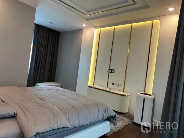 Detached House for sale in Suan Luang, Bangkok - Master bedroom feature wall with soft backlighting and floor-to-ceiling curtains.