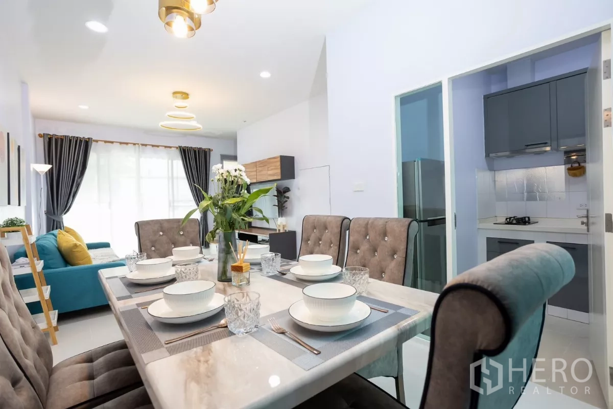 Townhouse for rent - Dining area set for six connecting to the living room and a glass-door kitchen