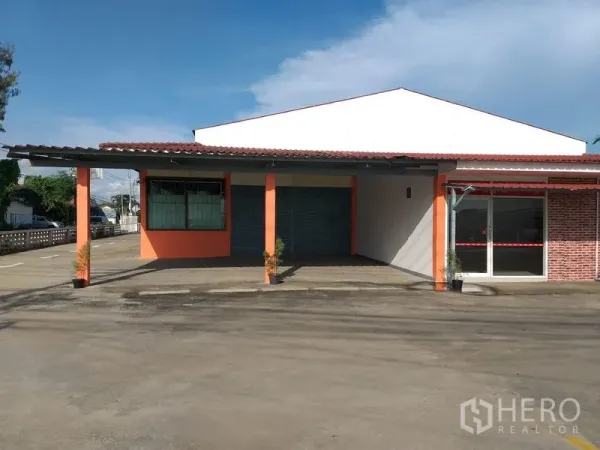 Warehouse for rent in Khlong Sam Wa, Bangkok - Main frontage with roller shutter bays, glass-fronted reception and large forecourt.