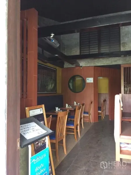 Retail Space for rent in Khlong Toei, Bangkok - Restaurant-style retail interior with wooden tables, booth seating, and dark exposed beams.