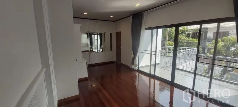 独立式住宅 出租在Pathum Wan, Bangkok - 楼上房间带壁柜，推拉玻璃门通向阳台