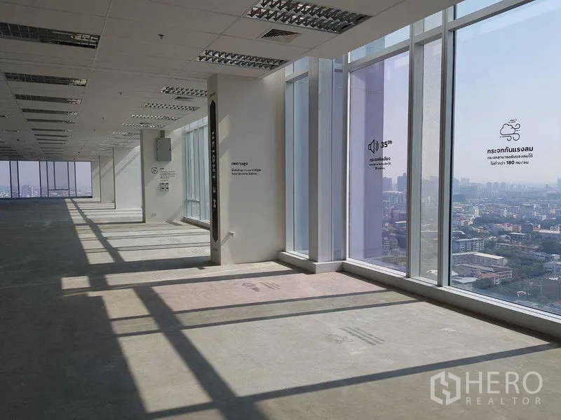 Office Space for rent - Unfurnished open-plan office floor with large panoramic windows and city views in Bang Kapi.