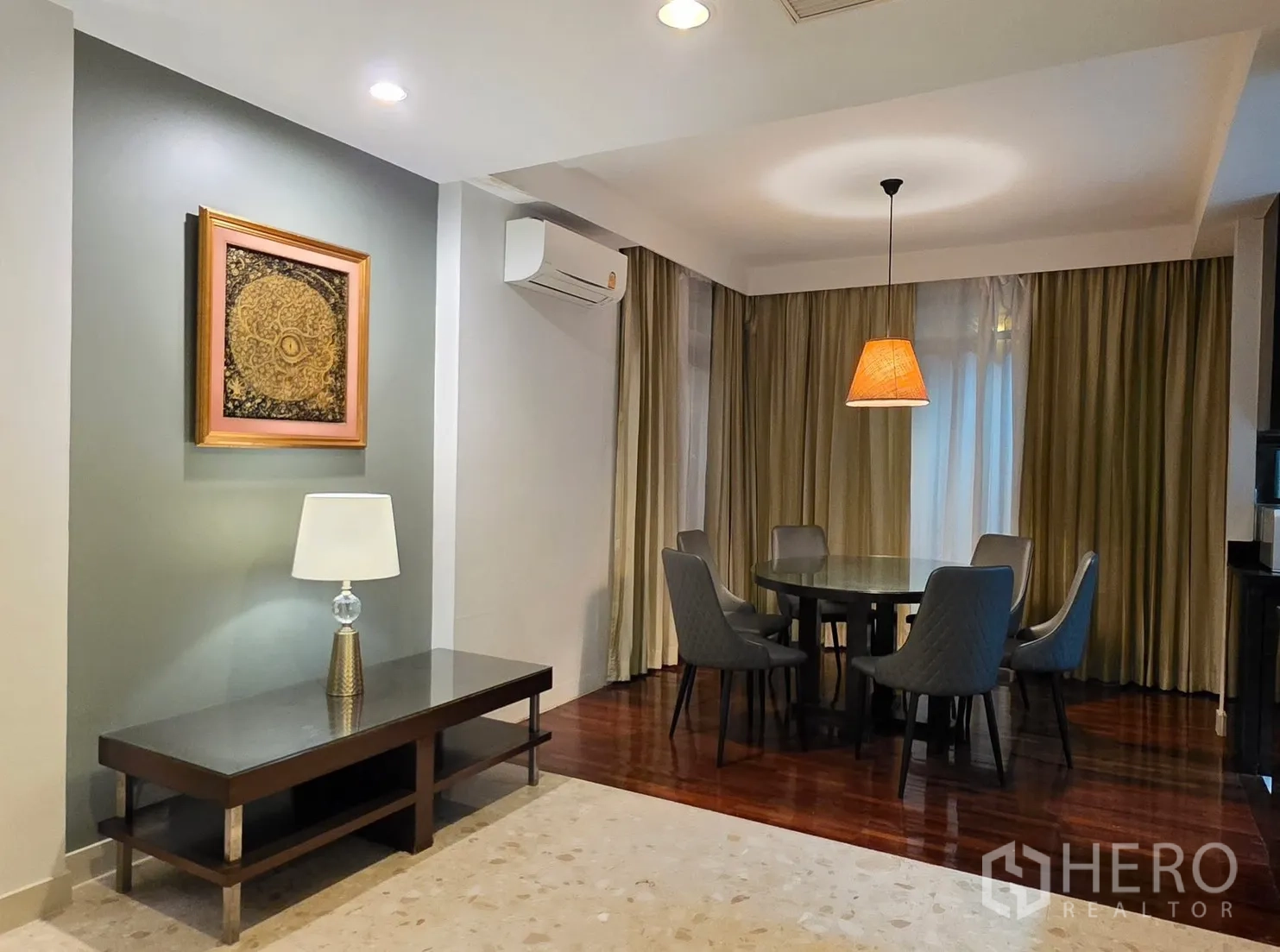 Detached House for rent in Wang Thonglang, Bangkok - Dining area with round table for six, pendant light, long curtains, and a console table.